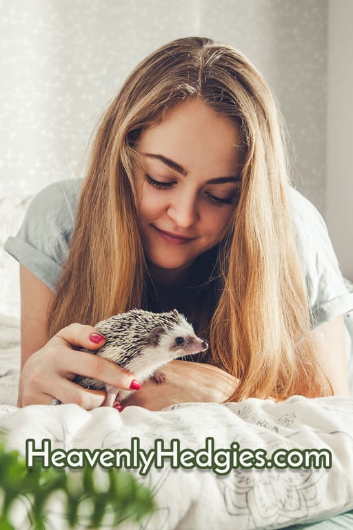a happy woman looking at her emotional support hedgehog